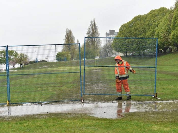  Crews put up fencing around the field at Sunset Beach Park April 22. Photo Dan Toulgoet