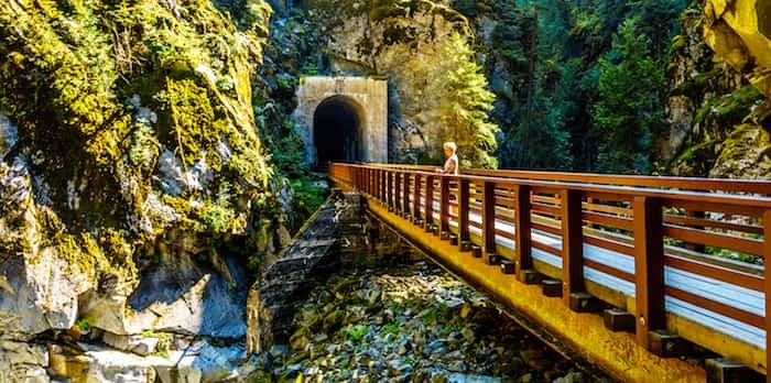  Bridges connecting the Othello Tunnels that were carved through the Coquihalla Canyon for the now abandoned Kettle Valley Railway at the town of Hope, British Columbia, Canada / Shutterstock