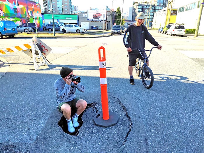  A man and his friend take advantage of the sinkhole on a sunny afternoon. Photo Bob Kronbauer