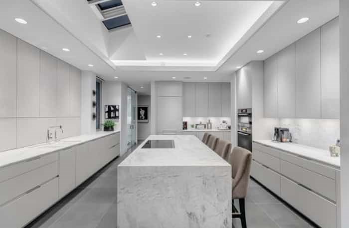  The Snaidero kitchen has custom cabinetry and a huge island with waterfall countertop. Listing agent: Eric Christiansen