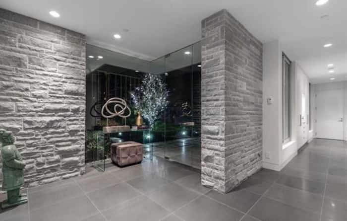  This home's sexy entrance foyer shows off a number of typical Hollingsworth features, such as an exposed interior stone wall and lots of glass. Listing agent: Eric Christiansen