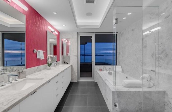  There's a lot of serene white and grey in this home, but it's broken by a pop of magenta to brighten the spacious master bathroom. Listing agent: Eric Christiansen
