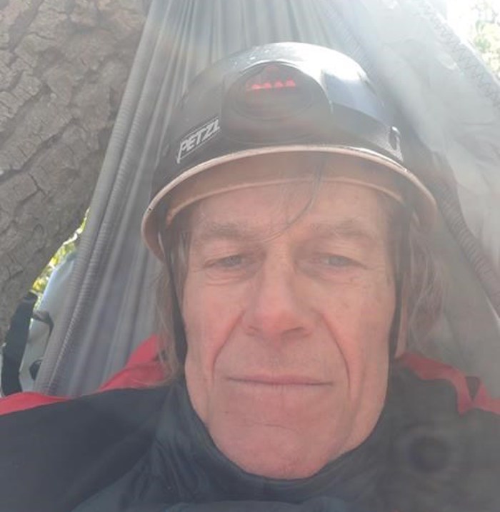  Terry Christenson is shown in a hammock in a tree in this recent handout photo. A 71-year-old grandfather says he is perched 30 metres up a tree overlooking Metro Vancouver's Burrard Inlet as he begins a mid-air demonstration against the Trans Mountain pipeline expansion. Speaking from a hammock strung from the branches, Terry Christenson said he selected the tree because it is inside the boundary of the Westridge Marine Terminal in Burnaby, B.C., the facility where oilsands crude arrives by pipeline and is shipped overseas. THE CANADIAN PRESS/HO - Stand.earth