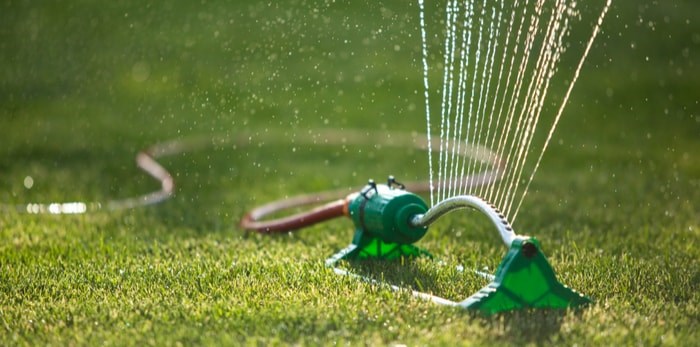  A sprinkler waters a lawn. Metro Vancouver will be on restricted water use from May 1 to Oct. 15. Photo via Shutterstock.