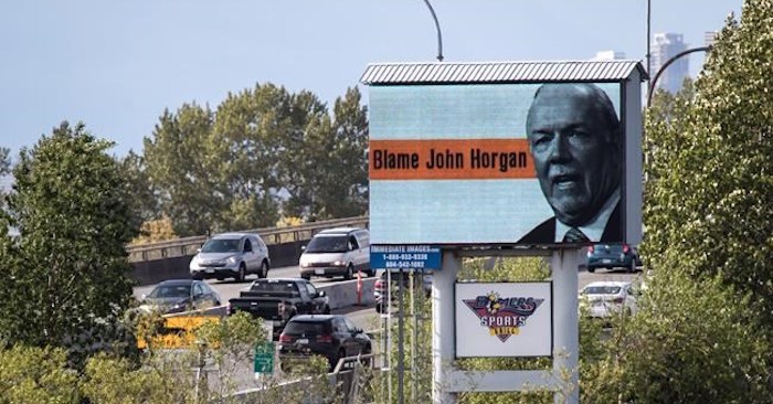  Motorists travel over the Alex Fraser Bridge as an electronic billboard paid for by the B.C. Liberal caucus, placing blame for high gas prices on Premier John Horgan is seen in Delta, B.C., on Saturday May 4, 2019. THE CANADIAN PRESS/Darryl Dyck