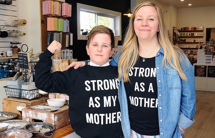  Tamara Komuniecki and nine-year-old son Finn sport her “Strong as a Mother” apparel at Komuniecki's Edgemont Village shop on Tuesday. Photo by Cindy Goodman/North Shore News