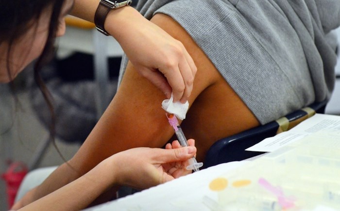  A Byrne Creek Community School student is injected with the measles vaccine. Photo by Cornelia Naylor