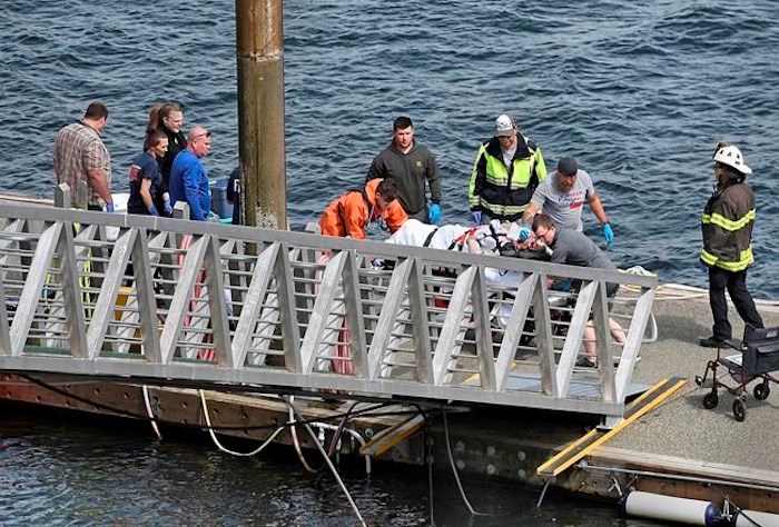  Emergency response crews transport an injured passenger to an ambulance at the George Inlet Lodge docks, Monday, May 13, 2019, in Ketchikan, Alaska. The passenger was from one of two float planes reported down in George Inlet early Monday afternoon and was dropped off by a U.S. Coast Guard 45-foot response boat. (Dustin Safranek/Ketchikan Daily News via AP)