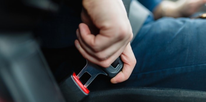  Putting on a seatbelt in the car/Shutterstock