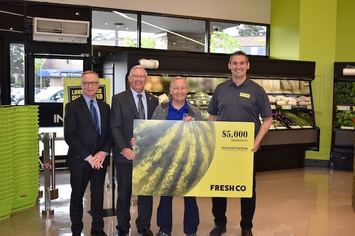  FreshCo general manager Rob Adams (far left) and owner of the Broadmoor location Scott Marshall (right) present Richmond Food Bank with a check for $5000. Photo by Alvin Chow