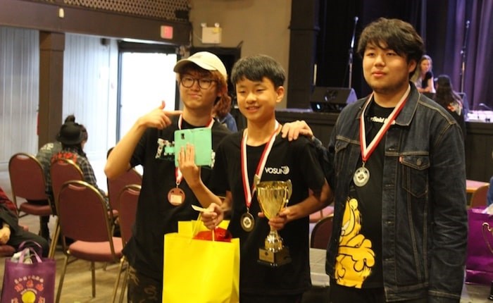  Richmond's Terrance Wang (centre) picks up his national title prizes. Photo submitted.