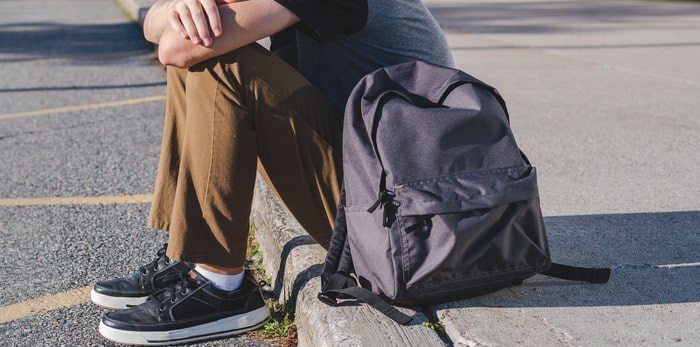  Sitting on the sidewalk/Shutterstock.