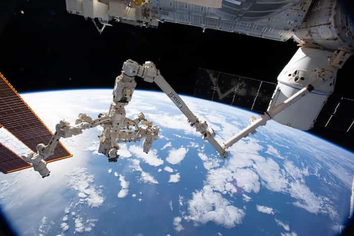  The Canadarm2 robotic arm with its robotic hand, also known as Dextre, attached for fine-tuned robotics work extends across the frame as the International Space Station orbited 256 miles above the Atlantic Ocean. Photo: NASA Johnson / 