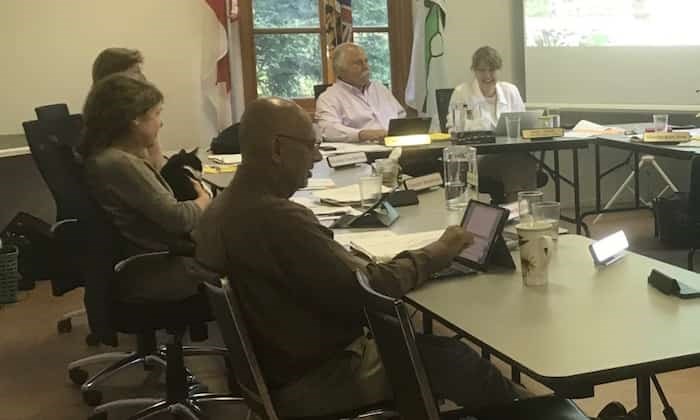  Bowen Island Coun. Maureen Nicholson holds Jax as council discussed electric vehicle charging, a topic on interest to one of Jax’s humans, James Glave. Photograph By Bronwyn Beairsto