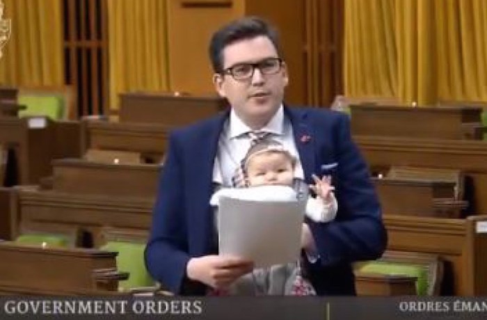  Terry Beech speaks in the House of Commons with his five-month-old daughter, Nova.