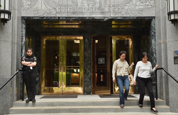  A security guard stands at her post Tuesday outside the main entrance to city hall. Photo Dan Toulgoet