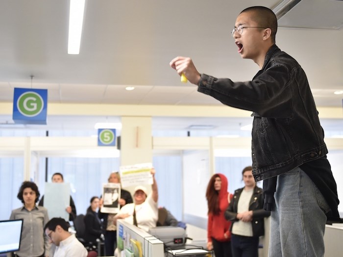  Housing activist Vincent Tao on top of a desk in the city's building and licences department in May 2018. Photo Dan Toulgoet