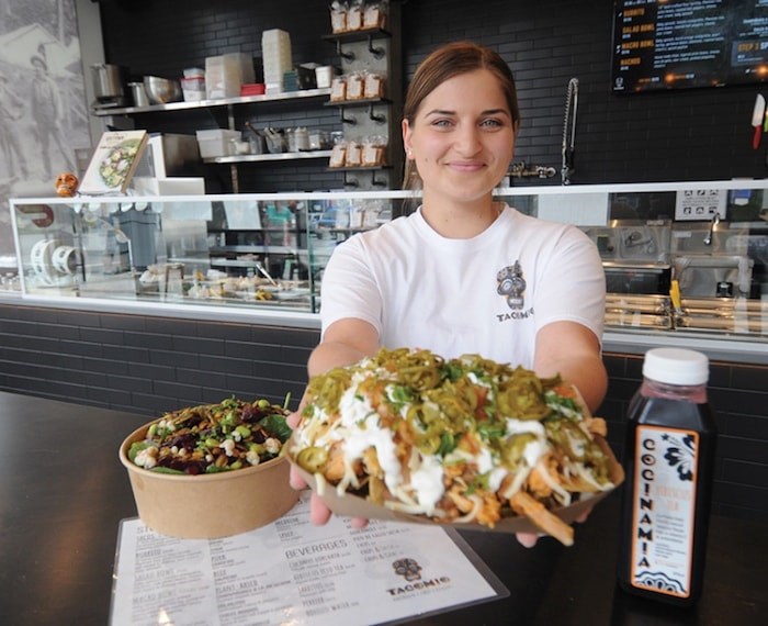  Mia Kaye offers up a plate of nachos at Tacomio on Lonsdale. Photo by Mike Wakefield/North Shore News