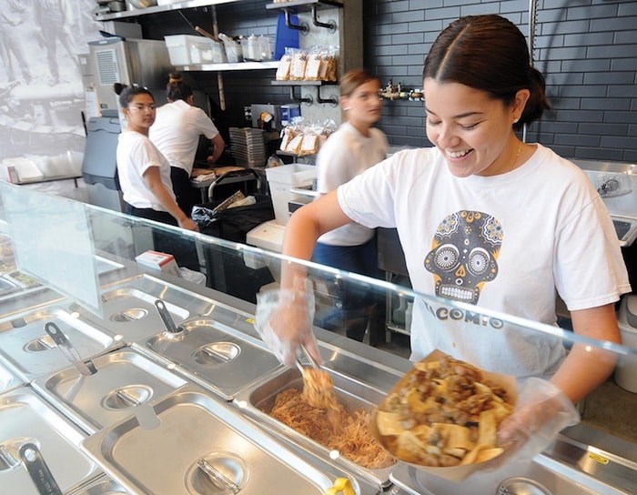  Melany Peres fixes a plate of nachos at the new Tacomio on Lonsdale. Photo by Mike Wakefield/North Shore News