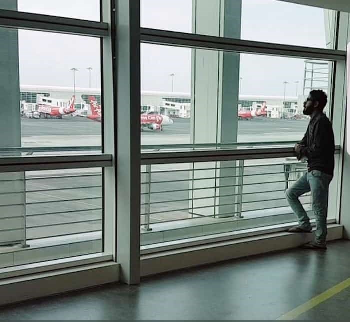  Hassan Al-Kontar looks out a window at the Kuala Lumpur International Airport, where he spent seven months waiting for a new home. - Courtesy Hassan Al-Kontar