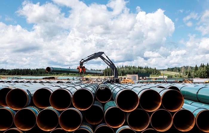  Pipe for the Trans Mountain pipeline is unloaded in Edson, Alta. on Tuesday June 18, 2019. THE CANADIAN PRESS/Jason Franson