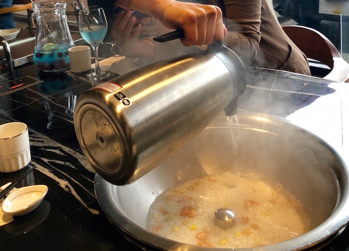  You can opt to get a simple or flavoured congee to go beneath your steam tray. The cooking gets kicked off with some hot water, then as your meal progresses, flavours from the steam tray drip down into the congee cooking below. Photo by Lindsay William-Ross/Vancouver Is Awesome