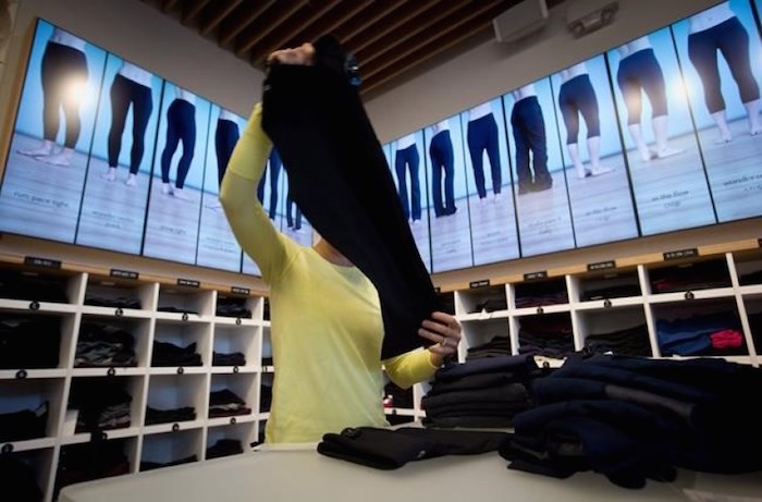  An employee folds yoga pants at a Lululemon Athletica store in Vancouver on August 21, 2014. The company wants customers to have more pea in their yoga pants. THE CANADIAN PRESS/Darryl Dyck