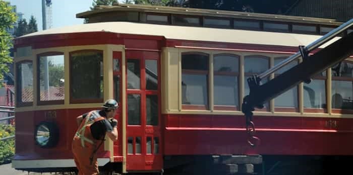  A crew from Nickel Bros. moving company inches the 111-year-old streetcar out from under the bleachers at Fen Burdett Stadium Wednesday. Photo: Mike Wakefield, North Shore News