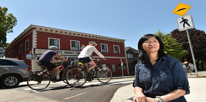  Janet Benedetti, who manages Benny’s Market, says the new raised crosswalk and street signs have had little effect on cyclists who continue to race by the store and fail to stop for pedestrians, particularly young children going to school. Photo Dan Toulgoet.