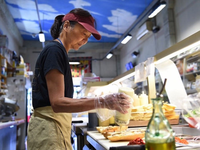  La Grotta Del Formaggio employee Lydia Lee prepares perfection on a Portuguese bun. Photo by Dan Toulgoet/Vancouver Courier