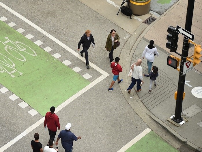  The City of Vancouver launched a trial this week at Hornby and Robson streets that allows pedestrians to simultaneously cross all four crosswalks at the intersection. Photo by Dan Toulgoet/Vancouver Courier
