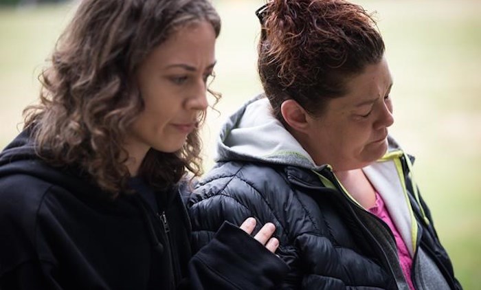  Wanda Stopa, right, who is currently living in a tent in a homeless camp, is comforted by Isabel Krupp, an activist with Alliance Against Displacement, during a gathering to remember friends, family and former residents who died in an area known as the 