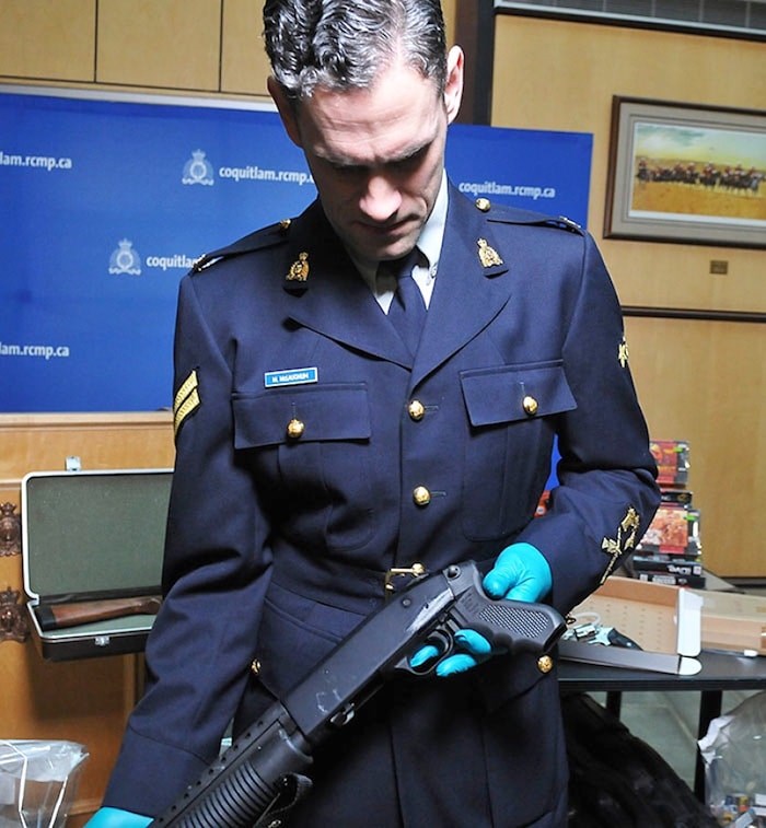  Coquitlam RCMP Cpl. Michael McLaughlin shows the filed-off serial number on a stolen gun. Photo via Burnaby NOW