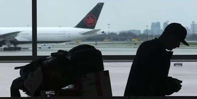  A passenger waits beside their luggage at the departure terminal at Toronto Pearson Airport, in Mississauga, Ont., Friday, May 24, 2019. Starting today, airline passengers can receive up to $2,400 if they'e bumped from a flight, part of a slew of air traveller protections beefing up compensation for travellers subjected to delayed flights and damaged luggage. Photo: The Canadian Press / Chris Young