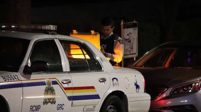  Burnaby RCMP were on the scene at an apparent carjacking that sent an 18-year-old male to hospital with stab wounds just after midnight Monday. Photo: Shane Mackichan