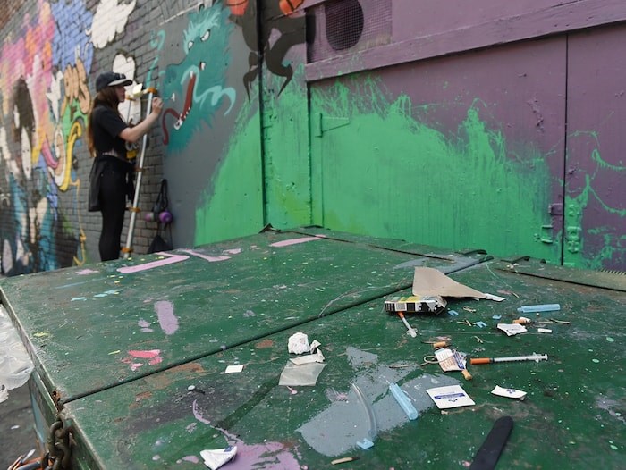  Drug use and overdoses are common themes in many of the murals in the alleyway behind the Overdose Prevention Society. Photo by Dan Toulgoet/Vancouver Courier