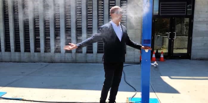  Photo: Coun. Pete Fry takes one of the city’s new misting stations for a spin at a media briefing July 25. Photo Bob Kronbauer / Vancouver Is Awesome