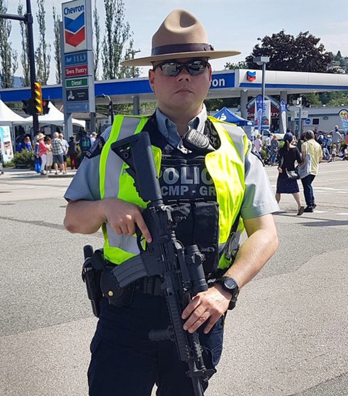  A photo posted on Twitter by local activist Harsha Walia shows a Burnaby RCMP officer carrying a semi-automatic rifle at Hats Off Day in June. - Photo: Twitter/ Harsha Walia