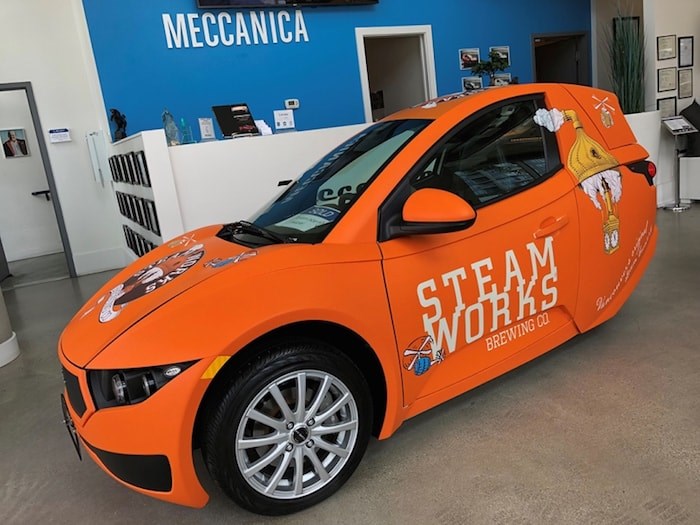  Steamworks’ Burnaby brewery is going green with their new, orange electric car, the single-passenger Solo by Vancouver-based Electra Meccanica. Photo courtesy Steamworks