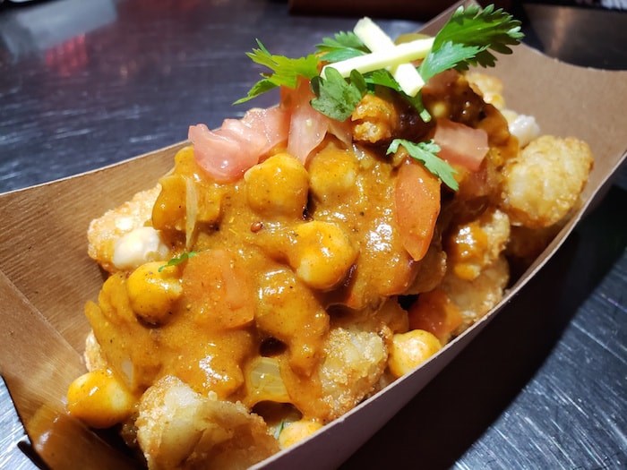  Chana Tater Tots: Tater tots topped with sliced onion, green chilies, diced tomato, chickpeas and sliced chicken, all tossed in a house-made chana masala sauce and garnished with fresh coriander and ginger. Photo courtesy PNE