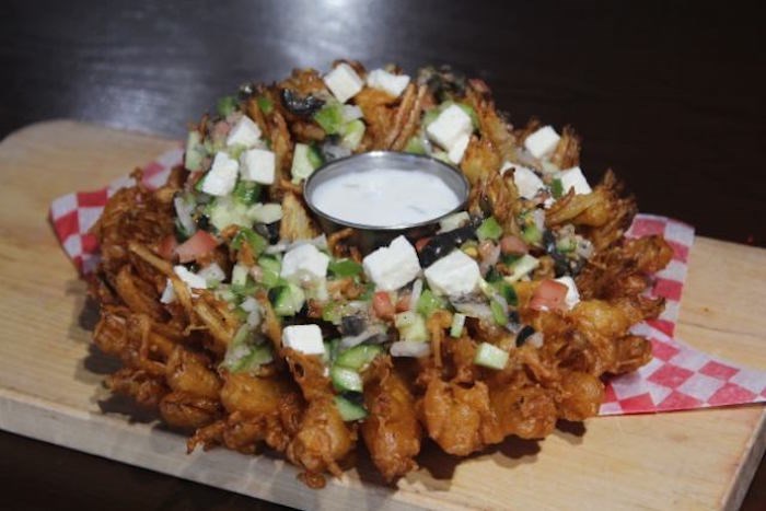  The Mighty Zeus Onion: whole onion cut and dipped in homemade batter and garnished with green pepper, red onion, tomato, feta cheese and more. Photo courtesy PNE