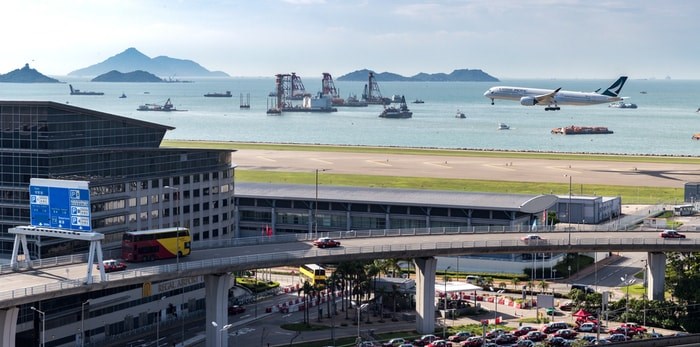  A plane lands at Hong Kong International Airport. EarnestTse/Shutterstock.com