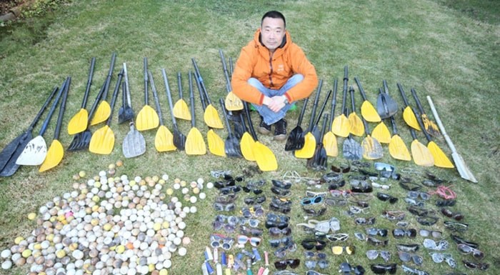  Henry Wang with garbage collected on a previous dive.