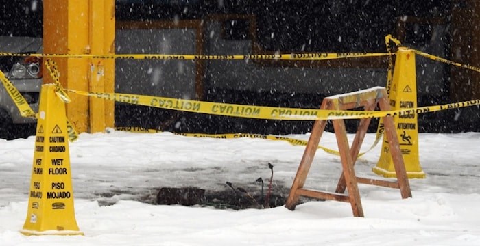  Caution tape cordons off an open junction box on a city sidewalk with wires exposed. Photo courtesy Mark Teasdale