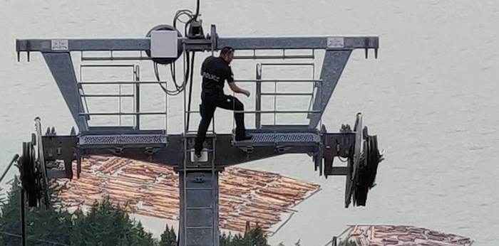 A member of the RCMP's Integrated Forensic Identification Services Team inspecting the crime scene. Authorities say the Sea to Sky Gondola was intentionally downed in the early hours of Saturday, Aug. 10. Photo: RCMP