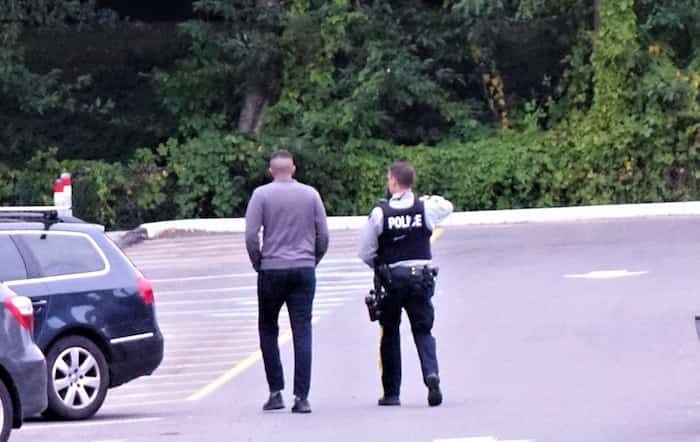 A Burnaby RCMP officer with a rifle at Deer Lake in Burnaby. Photo: John Preissl