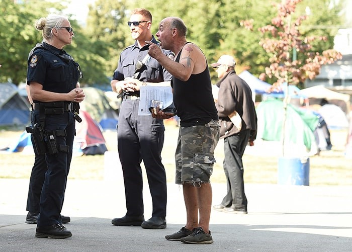  The Vancouver Police Department assisted park board staff Monday morning as campers at Oppenheimer Park were told they have to re-located into housing offered by the city or BC Housing. Photo: Dan Toulgoet