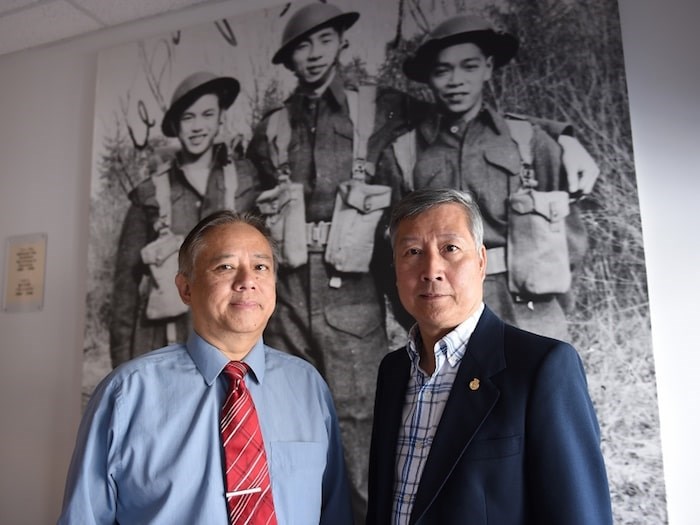  Glen Wong and King Wan, the president of the Chinese Canadian Military Museum Society. In the background is a photo with Glen’s father Bing Chew Wong on the far left. Photo by Dan Toulgoet