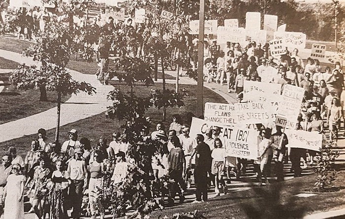  Hundreds of Tri-City residents and concerned people from other municipalities throughout the Lower Mainland carry protest signs as they march into Coquitlam Town Centre Stadium in the September 1994 rally, which demanded changes to the Young Offenders Act. - SIMONE PONNE/THE TRI-CITY NEWS