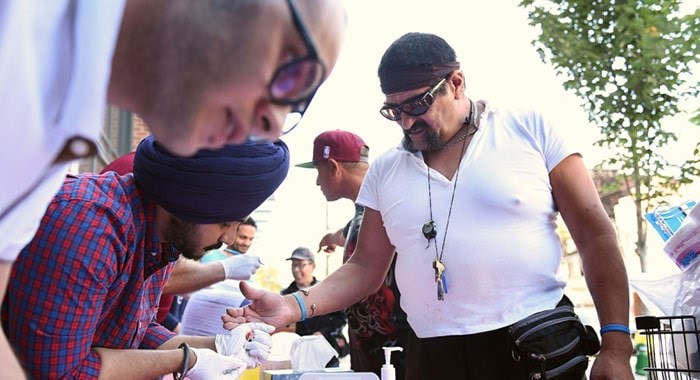  Vancouver Virology Centre Society volunteer Lovepreet Singh helps screen patients for HIV and Hepatitis C near Main and Gore streets on Aug. 22.Photograph By Dan Toulgoet